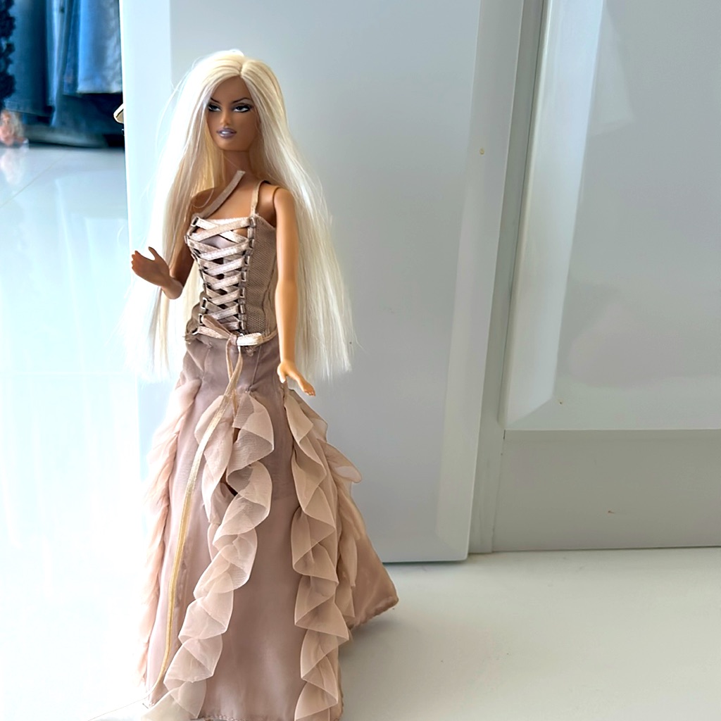 Versace’s Sister Donatello With Cream Corset-Style Dress With Ruffled Skirt